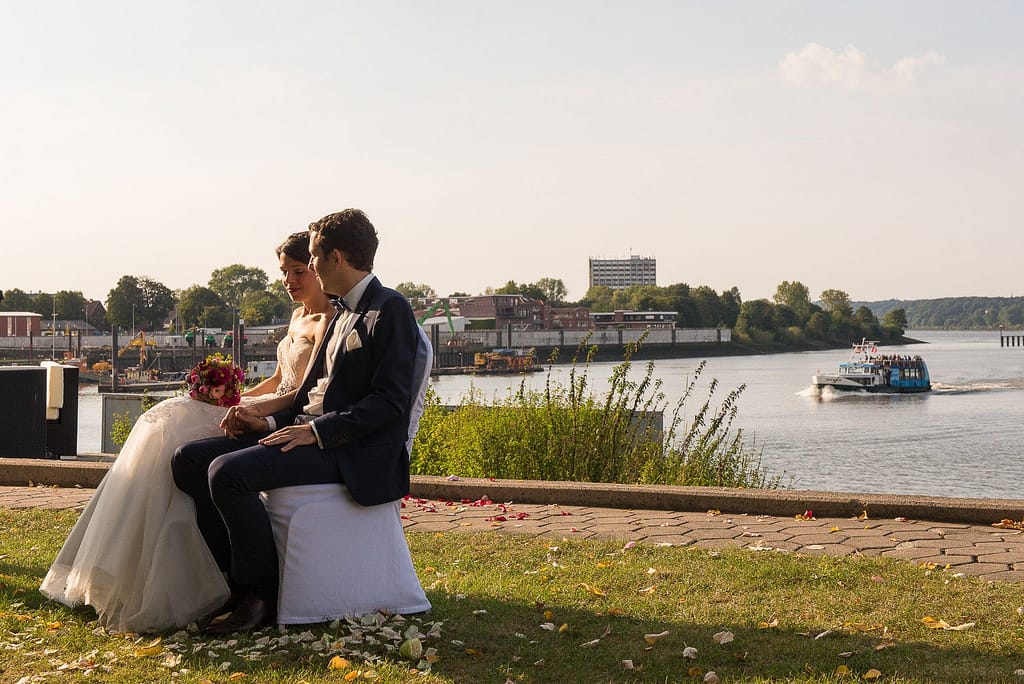 Das Hochzeitspaar lauscht der Traurede an der Villa im Jachthafen bei Hochzeitsfotografie Hamburg