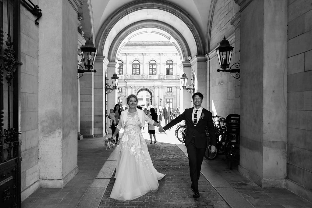 Das glückliche Hochzeitspaar verläßt händchenhaltend das Hamburger Rathaus nach der Trauung im Phönixsaal beim Hochzeitsfotograf Hamburg
