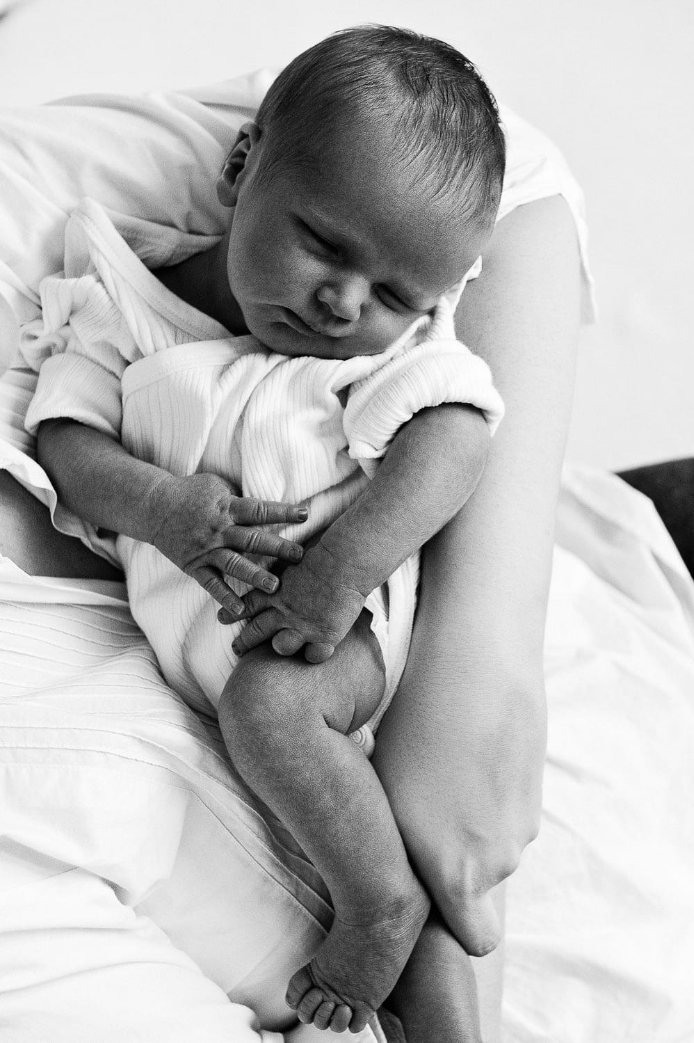 Mama hält ihr Baby im Arm bei der Neugeborenenfotografie in Hamburg Harburg